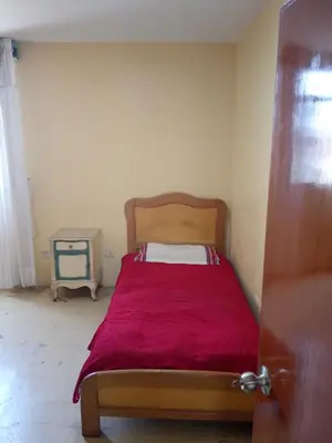 a bedroom with a bed with a red blanket at San Juan in Lima
