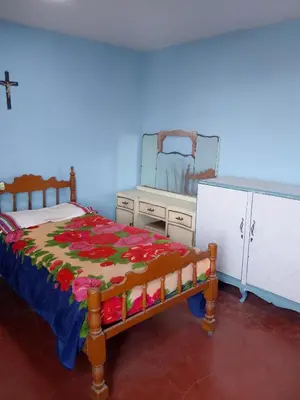 a bedroom with a bed and a dresser and a mirror at San Juan in Lima