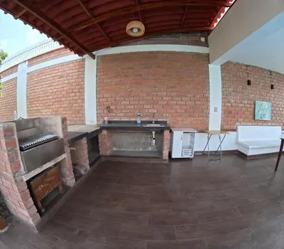 an outdoor patio with a brick wall and a sink at Casa de Campo Pachacamac in Pachacamac