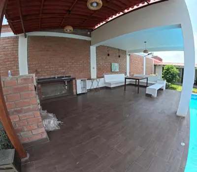 an outdoor patio with a fireplace and a brick wall at Casa de Campo Pachacamac in Pachacamac