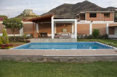 a swimming pool in the backyard of a house at Casa de Campo Pachacamac in Pachacamac