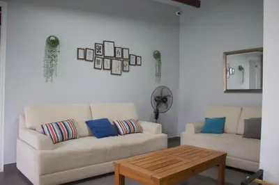 a living room with a couch and a coffee table at Casa de Campo Pachacamac in Pachacamac