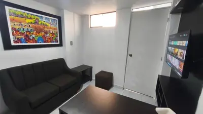 a living room with a couch and a table at mini departamento Andahuaylas in Andahuaylas