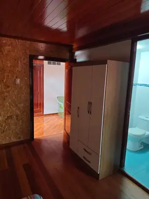 a bathroom with a cabinet and a toilet in a room at Oxapampa Center Room- habitacion centro in Oxapampa