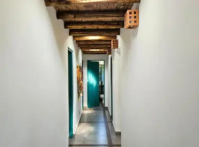 a hallway with white walls and a wooden ceiling at Spacious 4BR Country House with Pool in Mala in Asia
