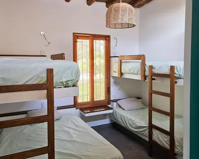 a room with two bunk beds and a window at Spacious 4BR Country House with Pool in Mala in Asia