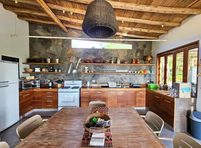a kitchen with a large wooden table in a kitchen at Spacious 4BR Country House with Pool in Mala in Asia