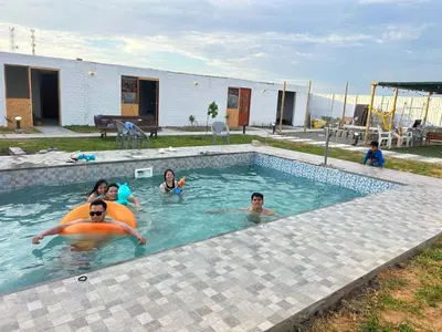 a group of people swimming in a swimming pool at Descanso del Guerrero - PARACAS in Paracas