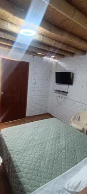 a bedroom with a large bed in a room at Descanso del Guerrero - PARACAS in Paracas