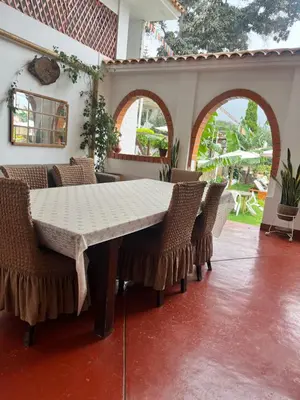 a dining room with a table and chairs at La Finca de la Norteñita 1926 in Santa Rosa de Quives