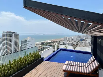 a balcony with a swimming pool on top of a building at Albano Penthouse íntimo piscina y vista al mar in Lima