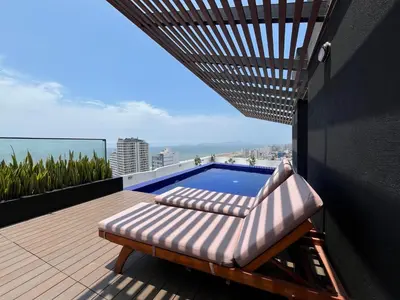 a balcony with a swimming pool on a building at Albano Penthouse íntimo piscina y vista al mar in Lima