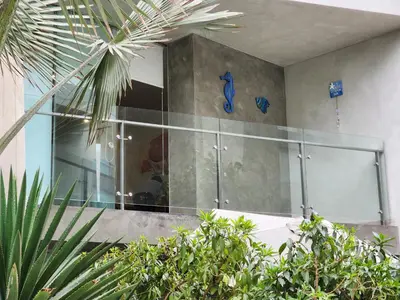 a glass shower in a building with plants at Condominio Ocean Reef Playa Norte San Bartolo in San Bartolo