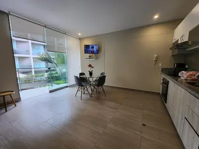 a kitchen and dining room with a table and chairs at Condominio Ocean Reef Playa Norte San Bartolo in San Bartolo