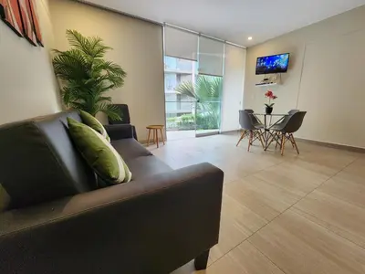 a living room with a couch and a table at Condominio Ocean Reef Playa Norte San Bartolo in San Bartolo