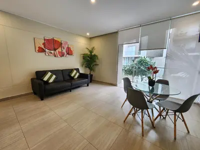 a living room with a glass table and a couch at Condominio Ocean Reef Playa Norte San Bartolo in San Bartolo