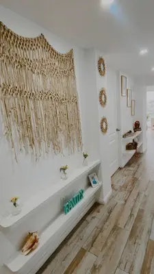 a room with a white wall with a curtain and a bench at Infinitive view San Bartolo in San Bartolo