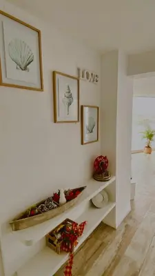 a room with a white wall with a shelf at Infinitive view San Bartolo in San Bartolo