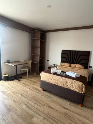 a bedroom with a bed and a table and a desk at Marina Selection Hotel in San Juan de Marcona