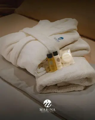 a pile of towels and products sitting on a bed at Marina Selection Hotel in San Juan de Marcona