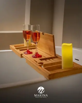 two glasses of wine sitting on a wooden tray at Marina Selection Hotel in San Juan de Marcona