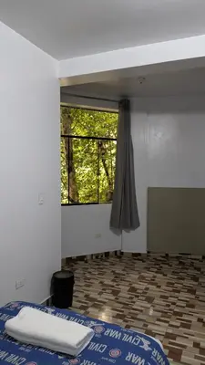 a bedroom with a bed and a window in a room at Aguilar Apaza Family in Machu Picchu
