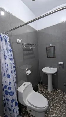a bathroom with a toilet and a sink at Aguilar Apaza Family in Machu Picchu