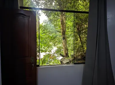 an open window with a view of a forest at Aguilar Apaza Family in Machu Picchu