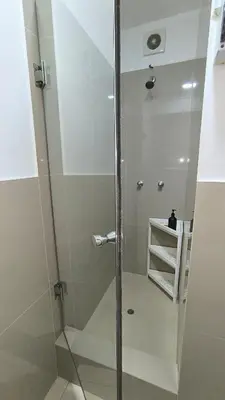 a shower with a glass door in a bathroom at Pueblo Libre 501 in Lima