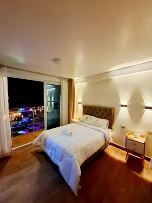 a bedroom with a large bed with a large window at MAR y LAGO EXPERIENCE in Lunahuaná