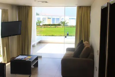 a living room with a couch and a large window at VPX Hotel in Asia
