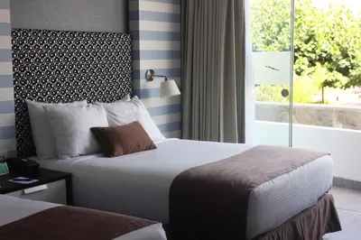a hotel room with two beds and a window at VPX Hotel in Asia