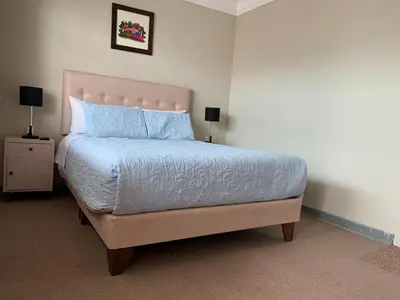 a bedroom with a large bed with blue pillows at Full Mini Apartment for 2 in Cusco