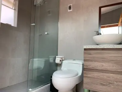 a bathroom with a shower and a toilet and a sink at Full Mini Apartment for 2 in Cusco