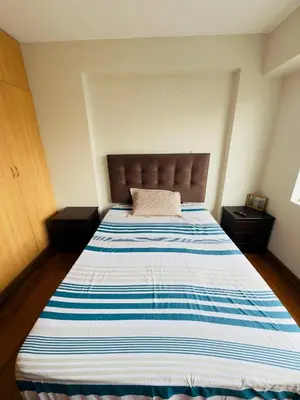 a bedroom with a bed with a blue and white striped mattress at Kira House in Lima