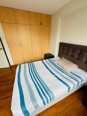 a large bed in a room with wooden cabinets at Kira House in Lima