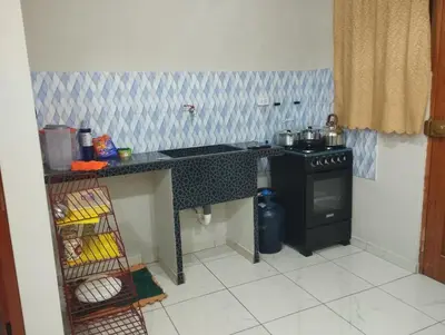 a kitchen with a stove and a counter top at Residencia PAZ Y BIEN in Cusco
