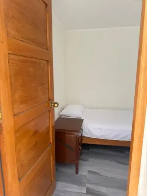 an open door to a small bedroom with a bed at San Borja Room Baño Compartido in Lima