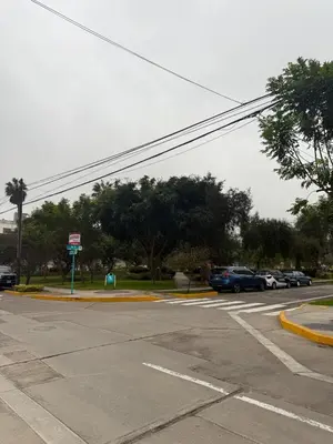 an empty street with cars parked in a parking lot at San Borja Room Baño Compartido in Lima