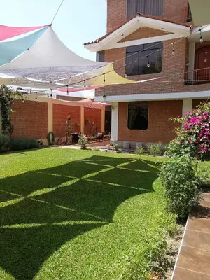 a yard of a house with a large lawn at Large quiet apartment in condominium in Santa Eulalia