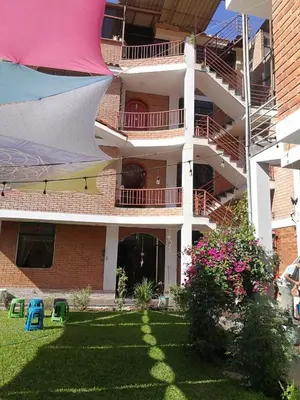 an apartment building with a yard with a building at Large quiet apartment in condominium in Santa Eulalia