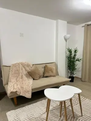 a living room with a couch and a table at Departamento de un solo ambiente in Lima