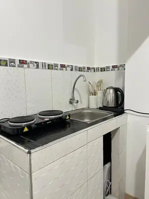 a kitchen with a sink and a counter top at Departamento de un solo ambiente in Lima