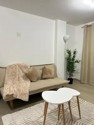 a living room with a couch and a table at Departamento de un solo ambiente in Lima