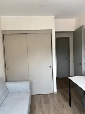 a living room with a couch and two closets at Beautiful brand new apartment for rent in Lima