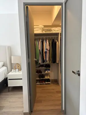 a walk in closet with a door open at Beautiful brand new apartment for rent in Lima
