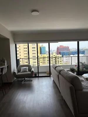 a living room with a couch and a chair at Beautiful brand new apartment for rent in Lima