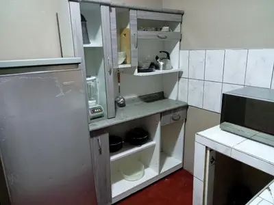 a small kitchen with a refrigerator and a microwave at Departamento 3 dormitorios 4A in Lima