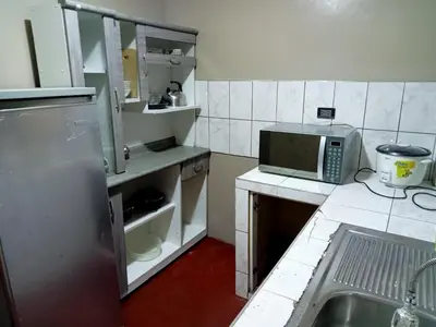 a small kitchen with a sink and a microwave at Departamento 3 dormitorios 4A in Lima