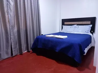 a bedroom with a blue bed with two towels on it at Departamento 3 dormitorios 4A in Lima